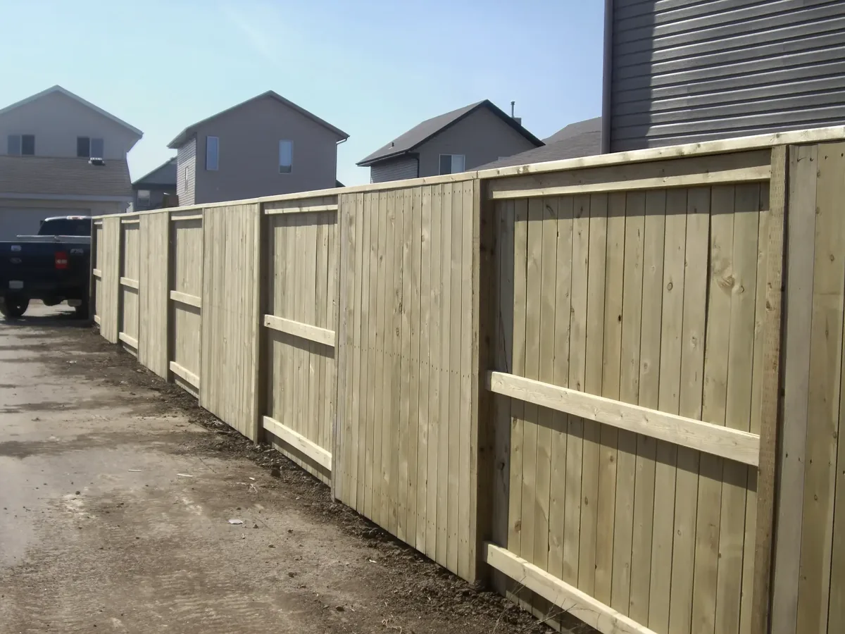 Wood privacy fence installed in Saskatoon with no-dig system