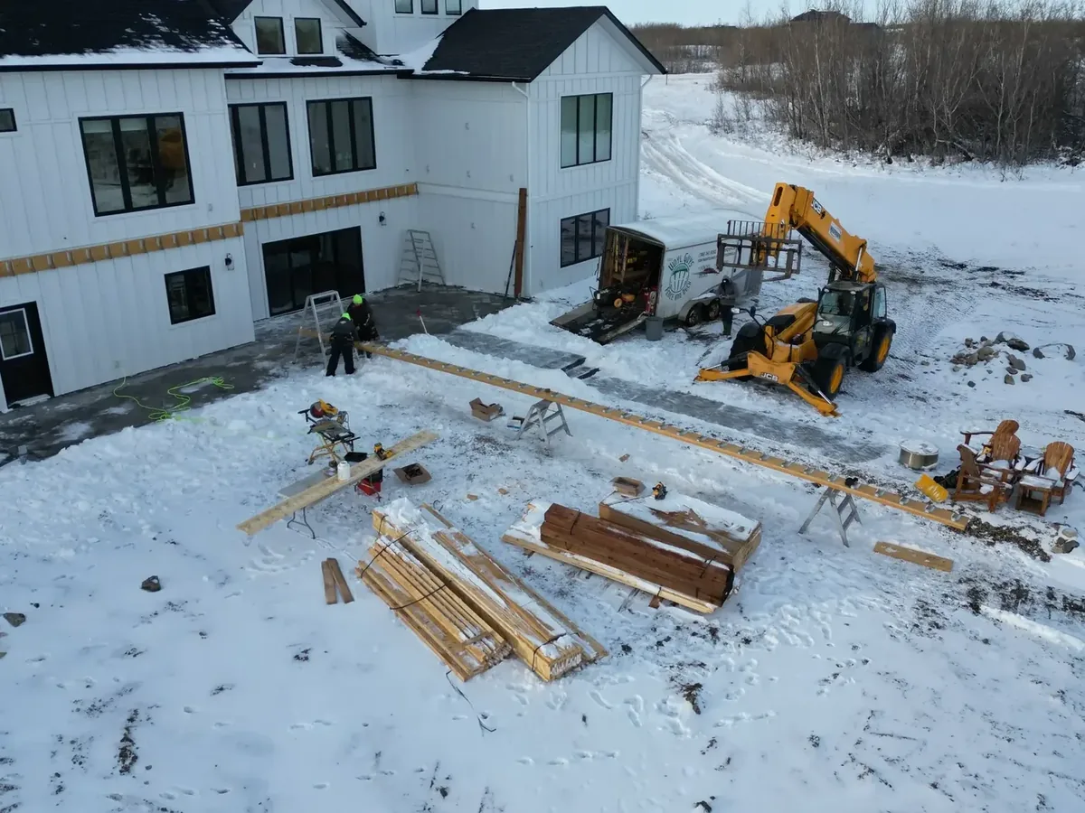 Aerial view of winter deck construction site Saskatoon with crew and equipment